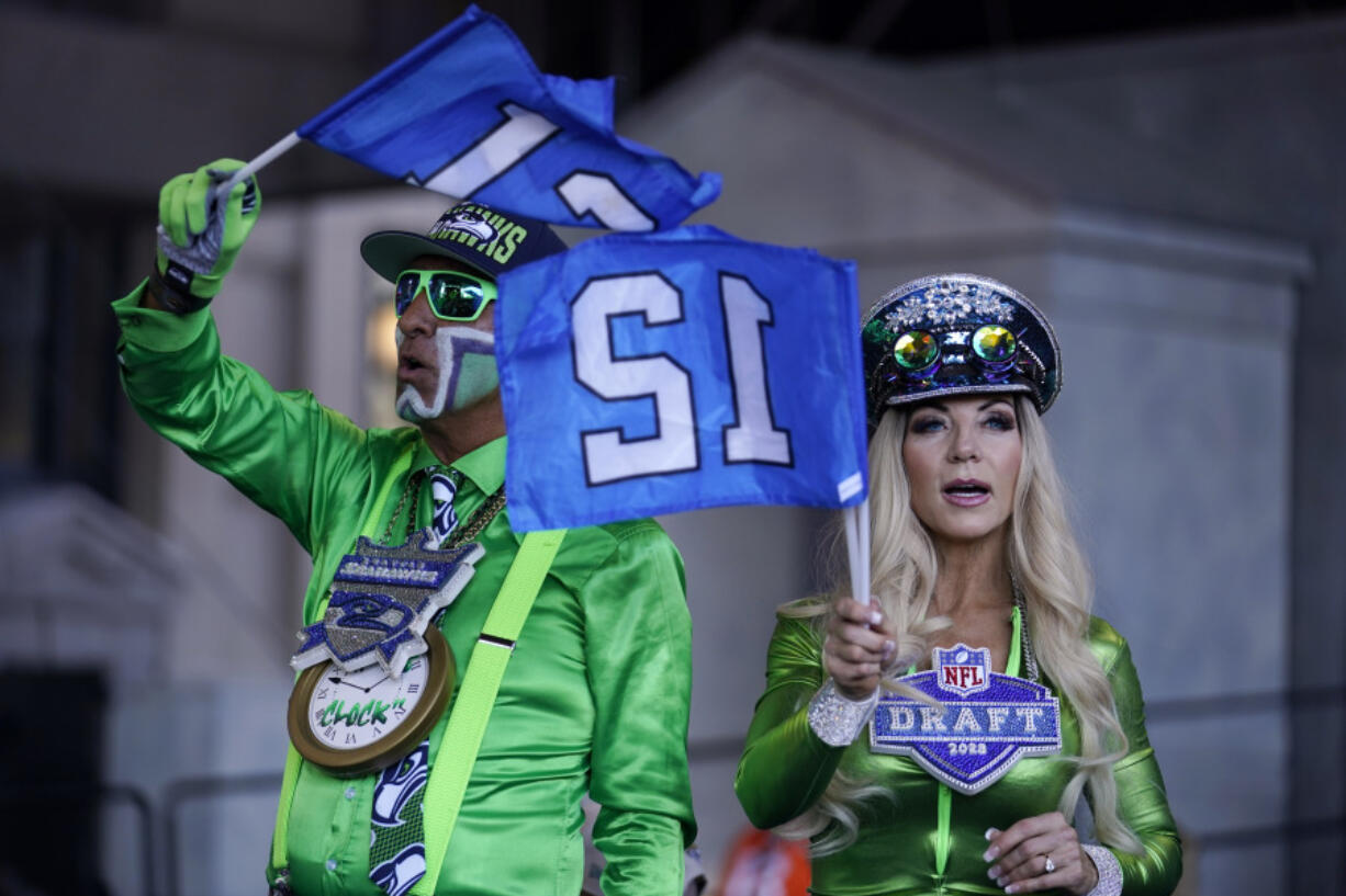 Seattle Seahawks fans cheer on the third day of the NFL football draft, Saturday in Kansas City, Mo.