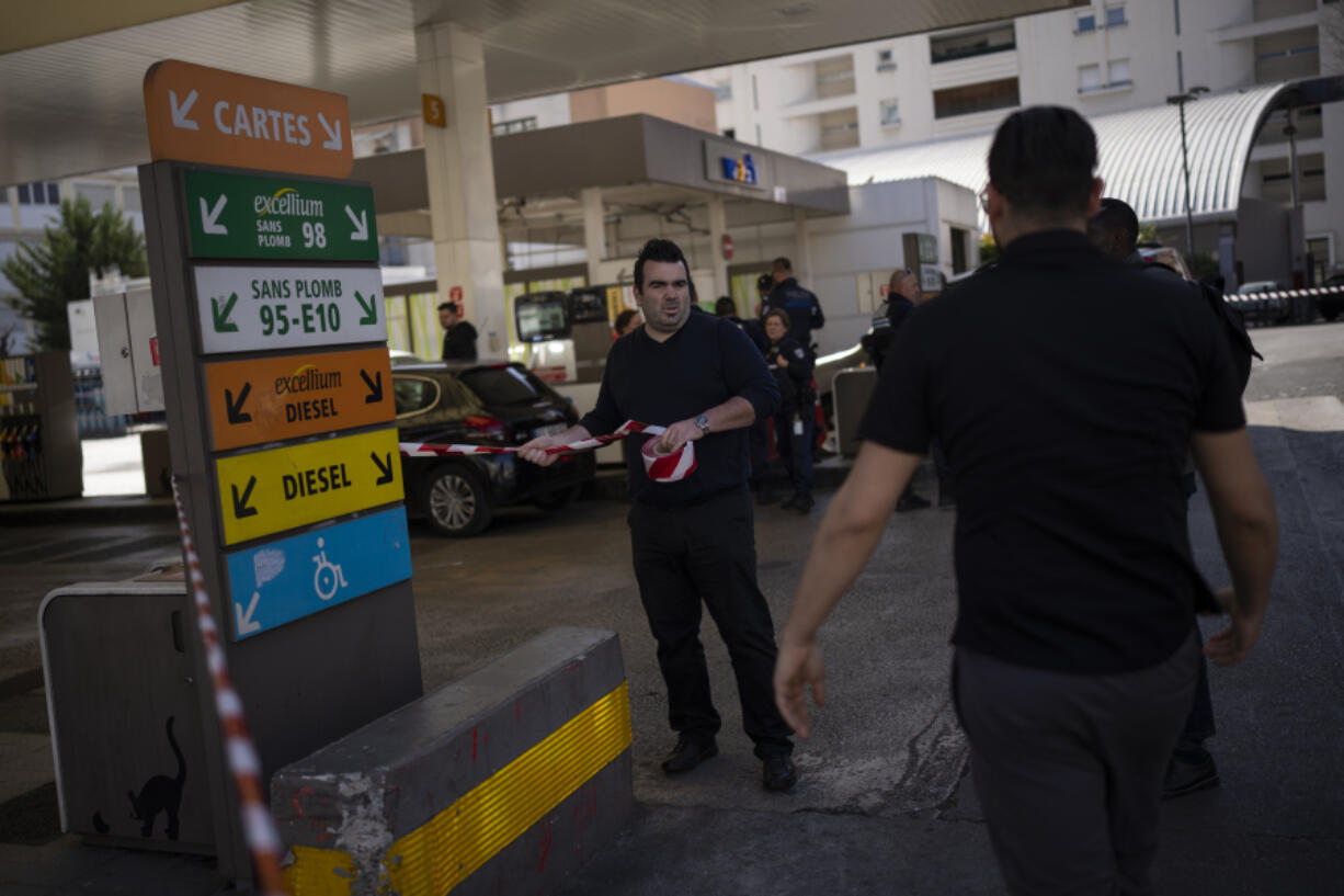 FILE - A gas station worker closes off a gas station in Marseille, southern France, on March 20, 2023. Major oil-producing countries led by Saudi Arabia and Russia have said they're throttling back supplies of crude -- again. And this time, the decision to cut back was a surprise that is underlining worries about where the global economy might be headed.