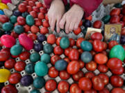 A vendor arranges hand-decorated Easter eggs, on Orthodox Good Friday at a green market, in Belgrade, Serbia, Friday, April 14, 2023. Orthodox Serbs celebrate Easter on April 16, according to the old Julian calendar.