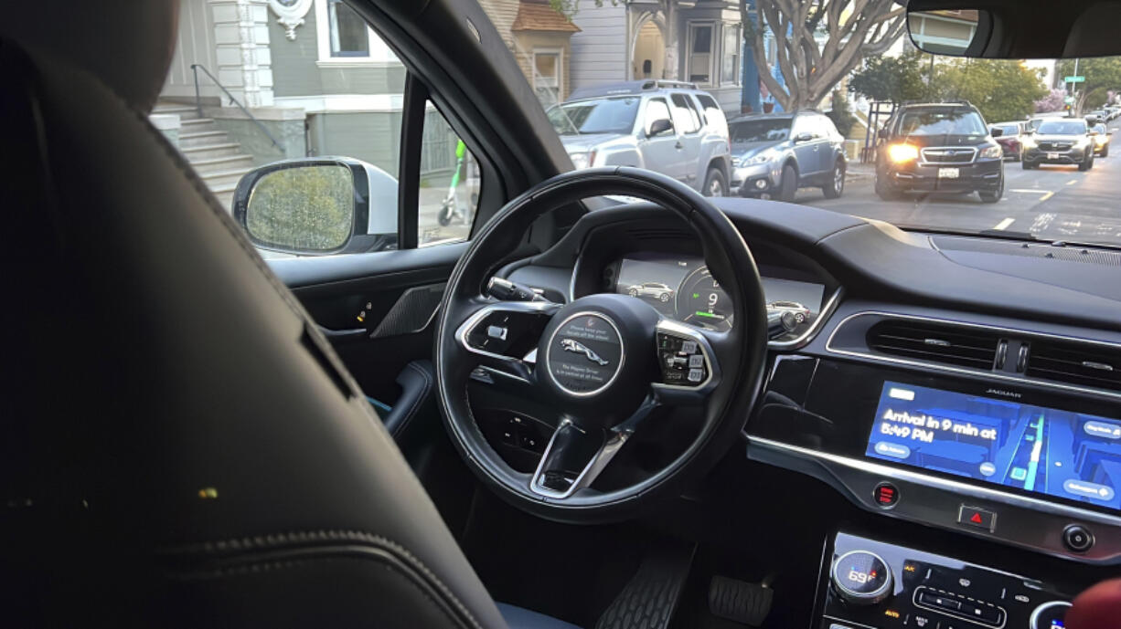 A Waymo driverless taxi drives on the street during a test ride in San Francisco, on Feb. 15, 2023. Cruise, a subsidiary of General Motors, and Waymo, a spinoff from Google, both are on the verge of operating 24-hour services that would transport passengers throughout one of the most densely populated U.S. cities in vehicles that will have no one sitting in the driver's seat.