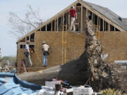 Work crews rebuild the walls to this Rolling Fork, Miss., home following the March 24 killer tornado destroyed much of the small town and also hit a number of Mississippi communities, on March 29, 2023. Many communities are in the midst of cleanup. (AP Photo/Rogelio V.