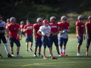 FILE - Simon Fraser University football team kicker Kristie Elliott, center, stands on the field with teammates during practice in Burnaby, British Columbia, Tuesday, Sept. 21, 2021. The only Canadian college with NCAA membership is shutting down its football program. Simon Fraser President Joy Johnson announced the decision in a letter Tuesday, April 4, 2023 saying that uncertainties about the future for the program led to the decision to discontinue it.