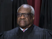 FILE - Associate Justice Clarence Thomas joins other members of the Supreme Court as they pose for a new group portrait, at the Supreme Court building in Washington, Oct. 7, 2022. Thomas has for more than two decades accepted luxury trips nearly every year from Republican megadonor Harlan Crow without reporting them on financial disclosure forms, ProPublica reports. (AP Photo/J.