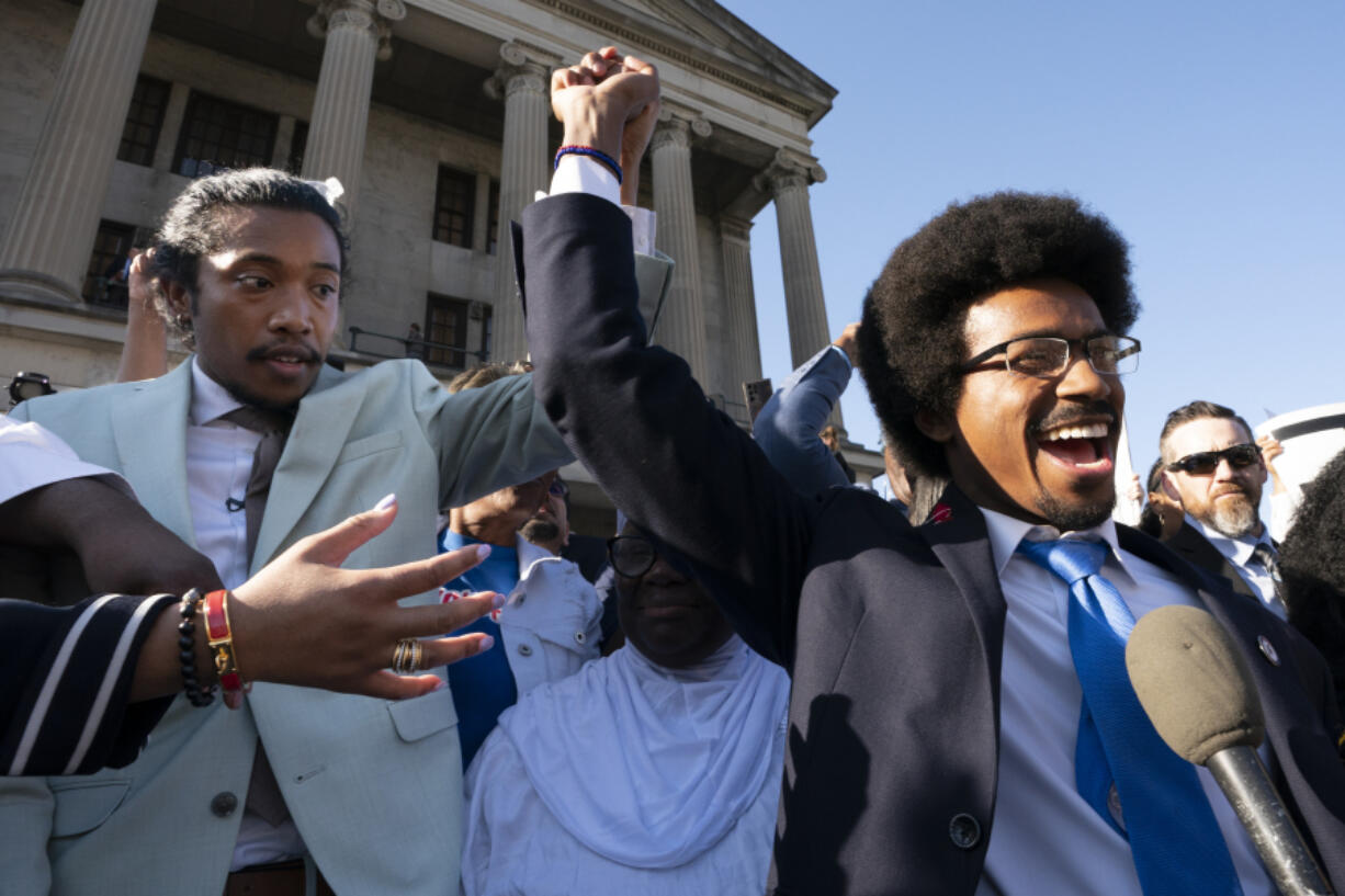 State Rep. Justin Jones, D-Nashville, and expelled Rep. Justin Pearson, D-Memphis, raise their hands just before Jones takes the oath of office outside the state Capitol Monday, April 10, 2023, in Nashville, Tenn. Jones, who along with Pearson was expelled last week over their role in a gun-control protest on the House floor in the aftermath of a deadly school shooting, was reinstated Monday after Nashville's governing council voted to send him straight back to the Legislature.