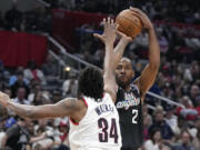 Los Angeles Clippers forward Kawhi Leonard, right, shoots as Portland Trail Blazers forward Jabari Walker defends during the second half of an NBA basketball game Saturday, April 8, 2023, in Los Angeles. (AP Photo/Mark J.