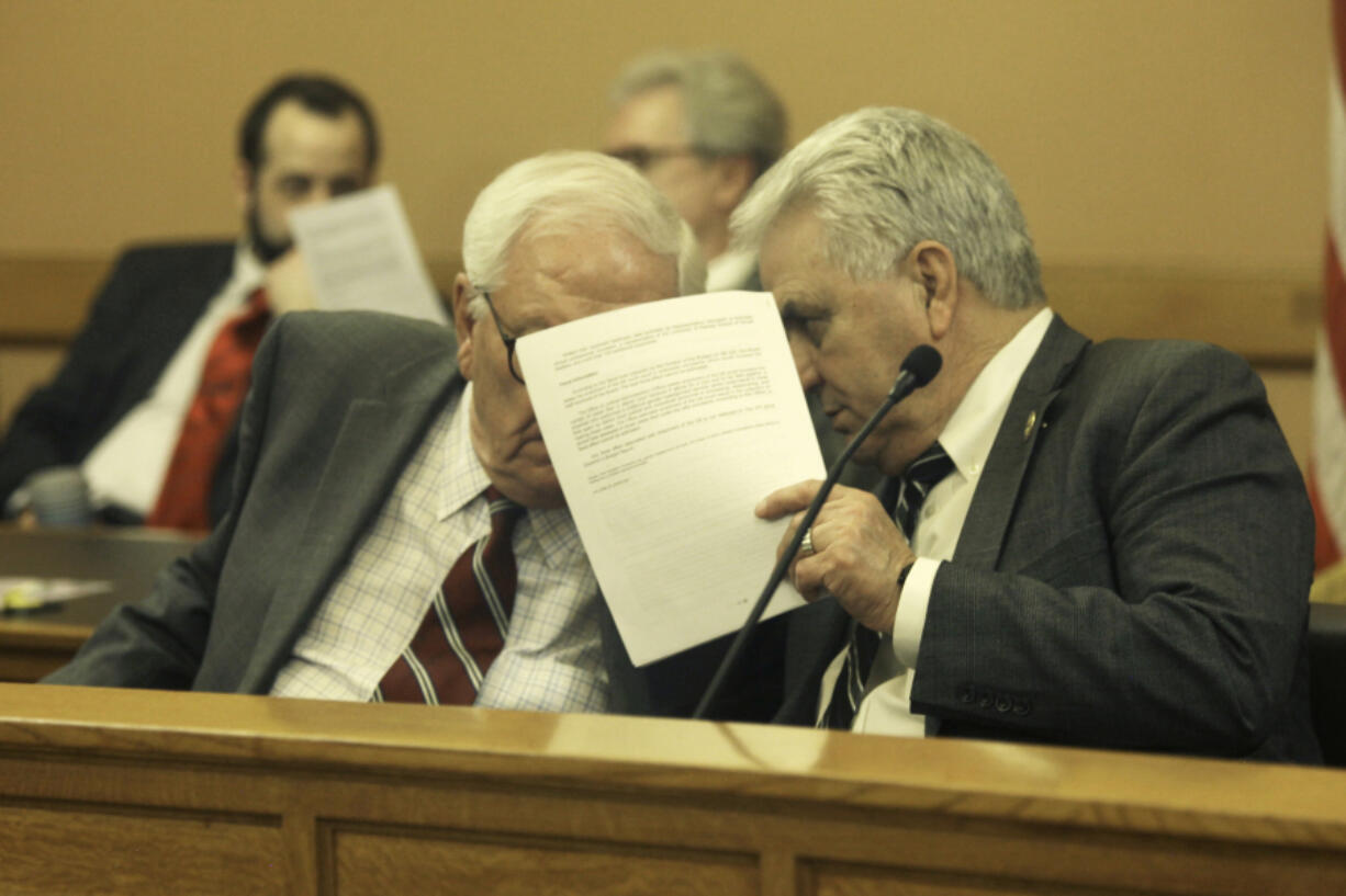 Kansas Senate Vice President Rick Wilborn, left, R-McPherson, consults with Senate Majority Leader Larry Alley, R-Winfield, during a caucus meeting of GOP senators, early Friday morning, April 7, 2023, at the Statehouse in Topeka, Kan. The meeting included a brief discussion of a bill for ending gender-affirming care for transgender minors, and senators approved it in their last action before beginning a spring break.