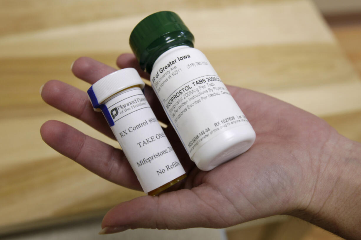 FILE - Bottles of abortion pills mifepristone, left, and misoprostol, right, at a clinic in Des Moines, Iowa, Sept. 22, 2010. A federal appeals court has preserved access to an abortion drug for now but under tighter rules that would allow the drug only to be dispensed up to seven weeks, not 10, and not by mail.