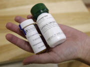 FILE - Bottles of abortion pills mifepristone, left, and misoprostol, right, at a clinic in Des Moines, Iowa, Sept. 22, 2010. A federal appeals court has preserved access to an abortion drug for now but under tighter rules that would allow the drug only to be dispensed up to seven weeks, not 10, and not by mail.