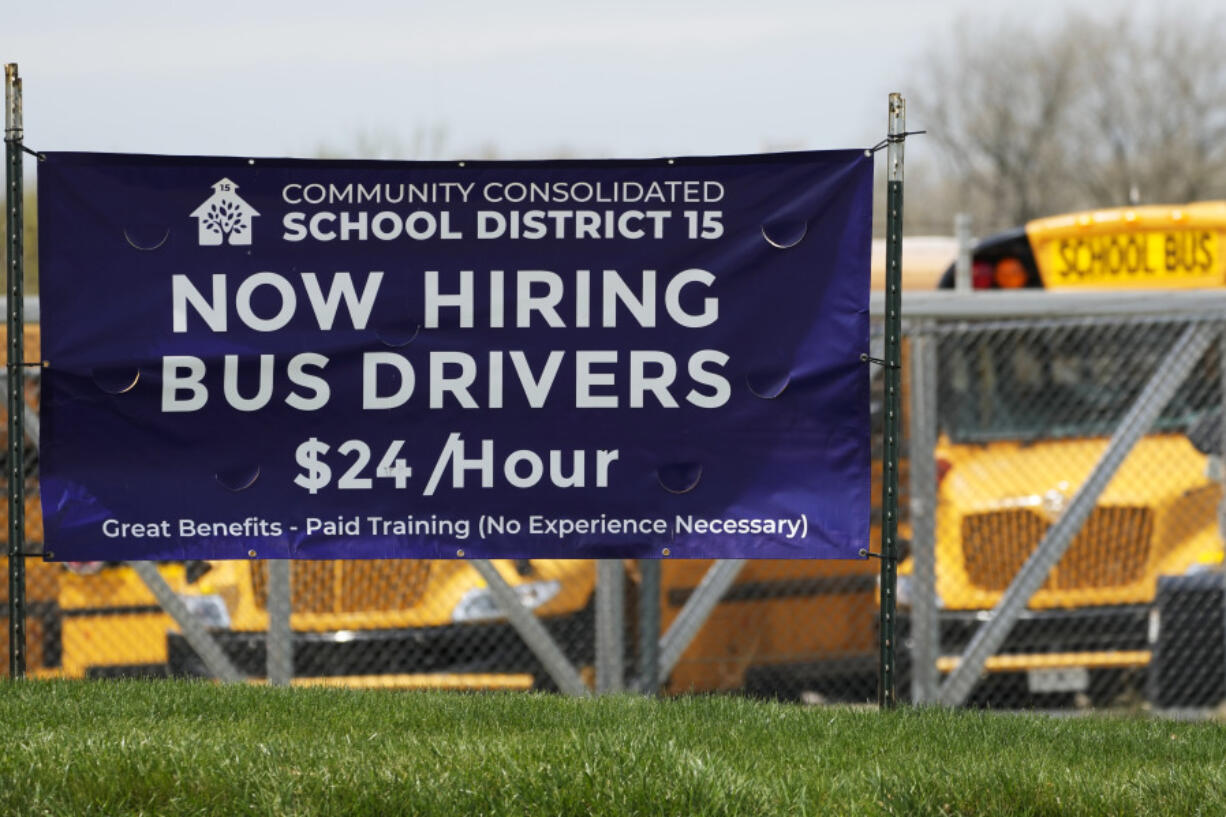 A hiring sign seeking bus drivers stands in Palatine, Ill., Wednesday, April 19, 2023. On Thursday, the Labor Department reports on the number of people who applied for unemployment benefits last week. (AP Photo/Nam Y.