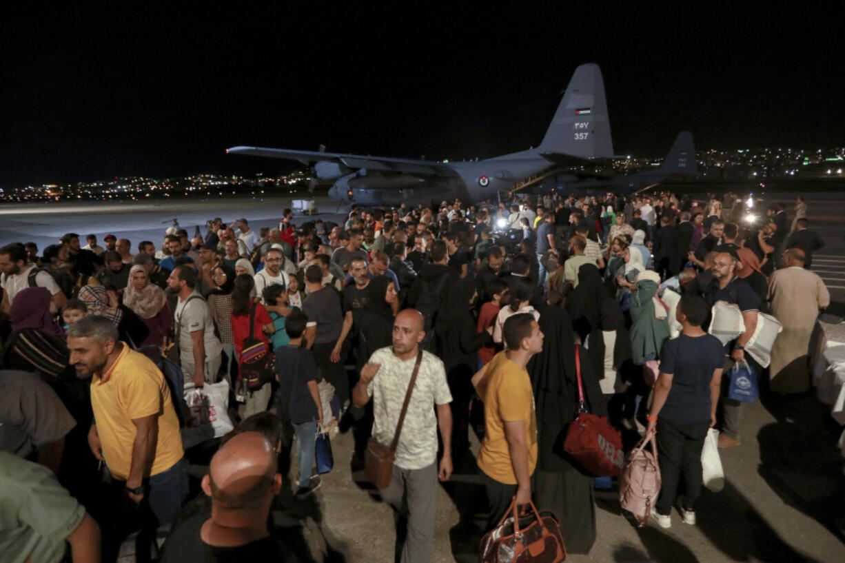 FILE - Jordanians evacuated from Sudan arrive at a military airport in Amman, Jordan, Monday, April 24, 2023. Warring factions trying to seize control of the east African nation of Sudan have plunged the country into chaos, and thousands are fleeing the capital of Khartoum and nearby battle zones. Some countries, including the U.S., have shuttered their embassies and many are coordinating daring evacuations of their staffs and other residents in an array of convoys, flights and frantic getaway drives.