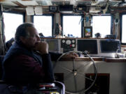 Bob Maharry sits inside his fishing boat docked at Pier 45 in San Francisco, Monday, March 20, 2023. This would usually be a busy time of year for Maharry and his crew as salmon fishing season approaches. On April 7, the Pacific Fishery Management Council, the regulatory group that advises federal officials, will take action on what to do about the 2023 season for both commercial and recreational salmon fishing. (AP Photo/Godofredo A.