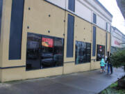 Kelly Moyer/Post-Record files 
 A family passes by Camas Slices in downtown Camas on April 10, 2021. A holding company affiliated with the nearby Journey Community Church recently purchased the former Camas Slices building on the corner of Northeast Cedar Street and Northeast Fourth Avenue in downtown Camas, as well as the adjacent building that once housed a State Farm insurance office. Church leaders say they plan to host community focus groups this spring to help gather ideas about how it might turn the former pizza shop into a youth-centered space.