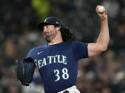 Seattle Mariners starting pitcher Robbie Ray throws against the Cleveland Guardians during the first inning of a baseball game Friday, March 31, 2023, in Seattle.