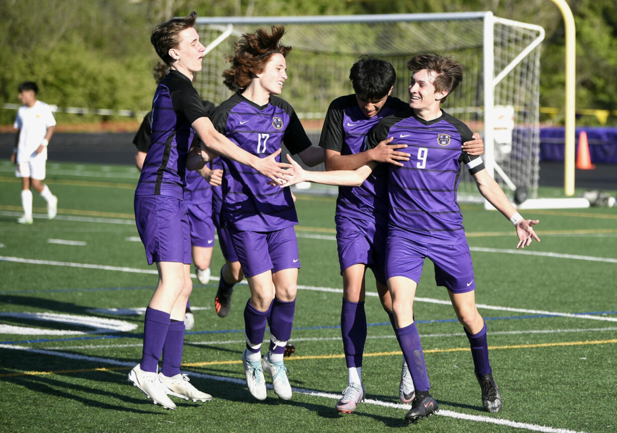 Columbia River players embrace after the Rapids scored their third goal against Aberdeen in the Class 2A District 4 boys soccer championship game on Thursday, May, 11, 2023, at Columbia River High School.