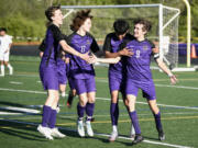 Columbia River players embrace after the Rapids scored their third goal against Aberdeen in the Class 2A District 4 boys soccer championship game on Thursday, May, 11, 2023, at Columbia River High School.