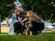 The Bauer family, Trish, 34, Josh, 36, and Lily, 10, hug their rescued German shepherd Cooper at Wildwood Park on May 3 in San Bernardino, Calif. Trish was scrolling on Instagram when she came across a post from a dog rescue that said a 12-year-old, 90 pound German shepherd was going to be euthanized if he didn't find a home soon.