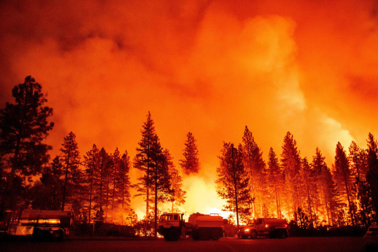 Water tender crews monitor a backfire during the Mosquito fire in Foresthill, an unincorporated area of Placer County, California on Sept. 13, 2022.