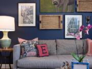 The sitting room's walls are dressed in a rich navy that complements the buttery velvet ottoman in the middle of the room and sets the tone for a bold and vibrant space that still brings an air of relaxation.