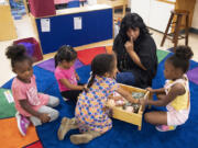 Teacher Tamara Harris playfully cautions Head Start students to stay quiet at Evergreen High School in 2022.