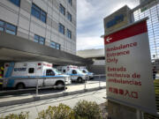 Ambulances deliver patients to Methodist Hospital in Arcadia. The hospital said it met the criteria for crisis care mode as it is now caring for 233 patients, more than half for COVID positive in isolation. Photographed at Arcadia on Wednesday, Jan. 6, 2021, in Arcadia, California. (Myung J.