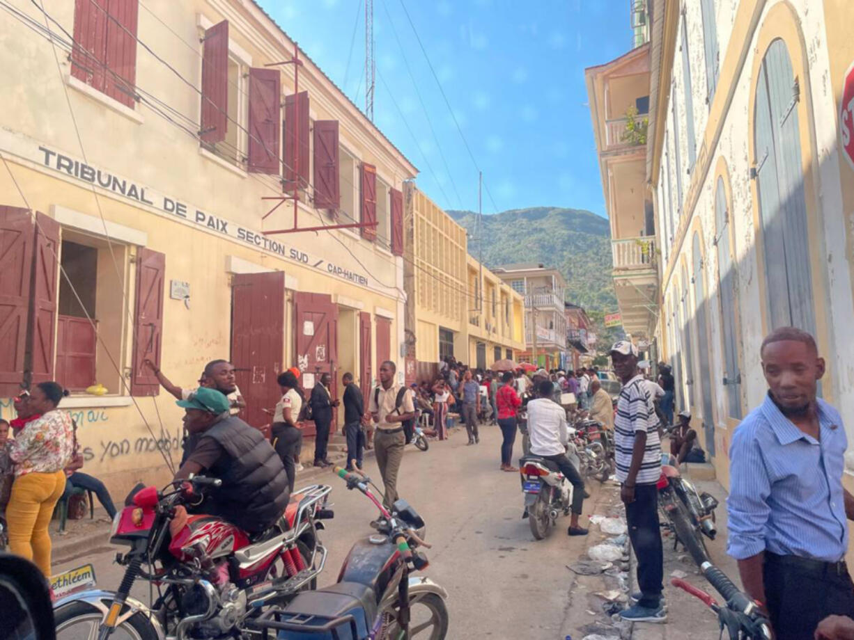 In Cap-Hav?tien, where a near riot almost broke out shortly after U.S. President Joe Biden announced a new parole program for nationals of Haiti and three other countries, people crowd the immigration office on Jan. 21, 2023. All are trying to apply for a passport so they can be considered for the program, which requires a financial sponsor in the U.S.