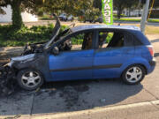 A Kia Rio after it crashed into an SUV Thursday afternoon on the St. John's Bridge in Portland and caught fire. Police say the crash pushed the SUV into the back of a pickup, and the driver of the Kia drove away from the scene.