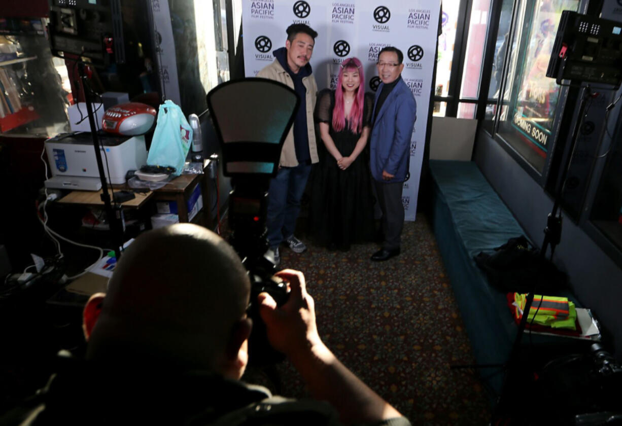 Filmmaker So Yun Eum, center, poses for pictures before the L.A. premier of her documentary. The film is called "Liquor Store Dreams" and features her father, Hae Sup Eum, right, and Danny Park, left. So Yun Eum is a second-generation Korean American and the film is about the Korean American merchant class.