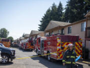 Pete Adams of the Vancouver Fire Department works at the scene July 28, 2022, as firefighters respond to a two-alarm fire at the Birchwood Lane Apartments. The blaze was contained to one downstairs unit, and no injuries were reported.