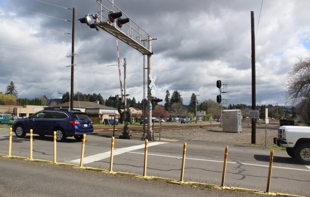 Traffic proceeds north on 32nd Street across a set of railroad tracks in Washougal.