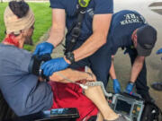 A man who was reportedly beaten by teenagers with skateboards Tuesday afternoon at Esther Short Park is treated by medical personnel.