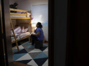 Maryam Azizpour reads "The Smart Cookie" to her daughters, 6-year-old Murwarid, top bunk, and 10-year-old Marwa, as they settle into bed one night in June 2022. One year earlier, the family was living an uncertain life in Kabul, Afghanistan, which was shortly to fall to the fundamentalist Taliban regime. Now, they have been granted asylum in the United States and made a new home in Hazel Dell.