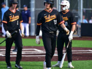 Prairie sophomore Isaac Watson, center, walks away after getting tagged out at home Tuesday, May 9, 2023, during the Falcons’ 12-4 loss to Gig Harbor in a 3A bi-district playoff game at the Evergreen Athletic Annex.