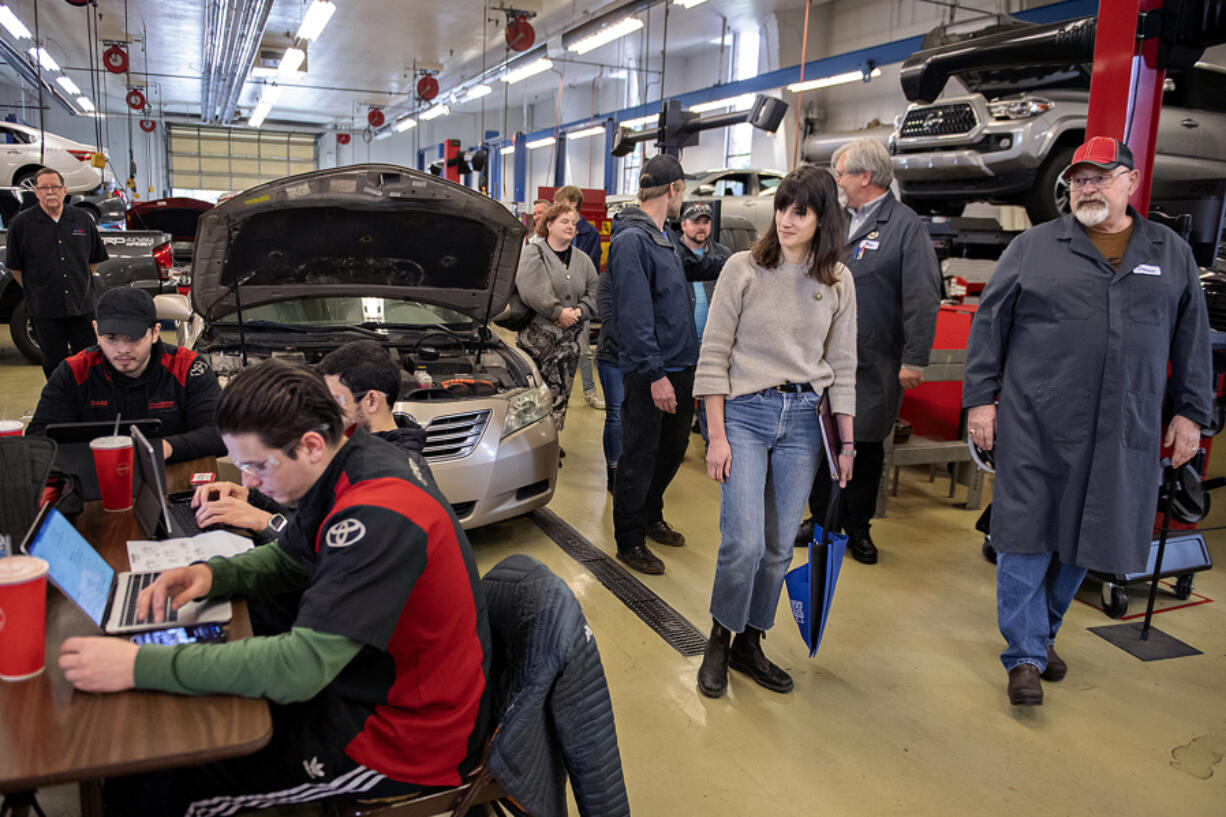 Rep. Marie Gluesenkamp Perez, second from right, joins Dannie Nordsiden of Clark College, right, on a tour of the auto shop as students work nearby on May 5. The Skamania Democrat who ran an auto repair shop until she was elected last year to represent Southwest Washington. Perez has supported two bills that would give consumers and independent repair shops access to the parts, tools and data needed to repair cars at lower costs.