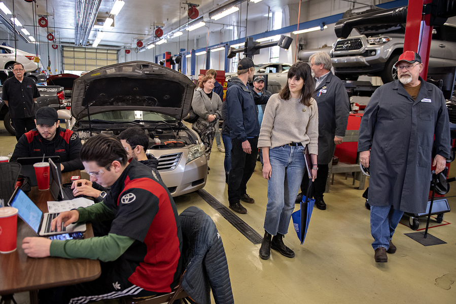 U.S. Rep. Marie Gluesenkamp Perez, second from right, joins Dannie Nordsiden of Clark College, right, on a tour of the auto shop as students work nearby Friday afternoon. The tour also included a visit to the diesel instruction area and the welding instruction area.