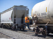 Portland Vancouver Junction Railroad conductor Brad Johnston rides along the Chelatchie Railroad line while working near St. Johns Road. On Wednesday, the Clark County Council continued its debate on whether to allow heavy industrial development along the line.