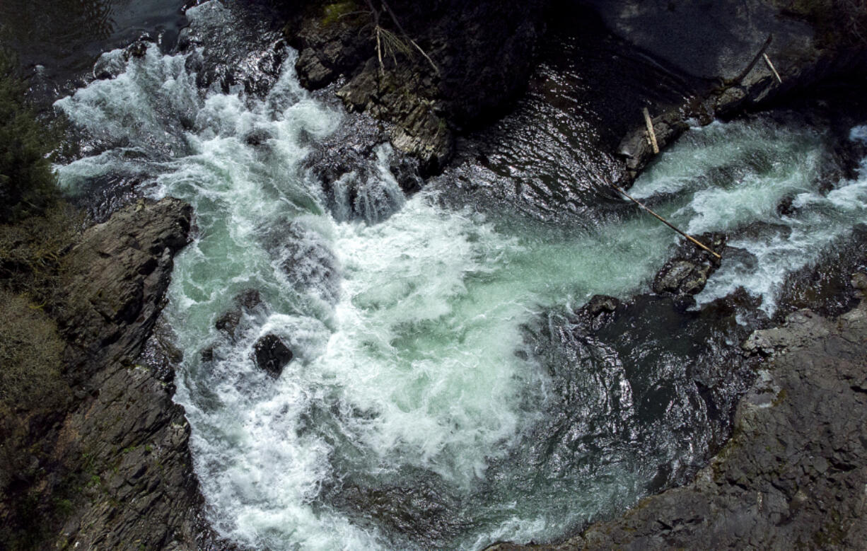 Springtime sunshine illuminates rushing water as it pours over the rocky cliffs of Lucia Falls, as seen in a drone photo. Forecasters predict the sunshine will stay around for the rest of the week with summerlike temperatures over the weekend.