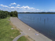 People sunbathe and play in the water Monday at Vancouver Lake. Temperatures are expected to remain in the mid- to upper 80s until the weekend.