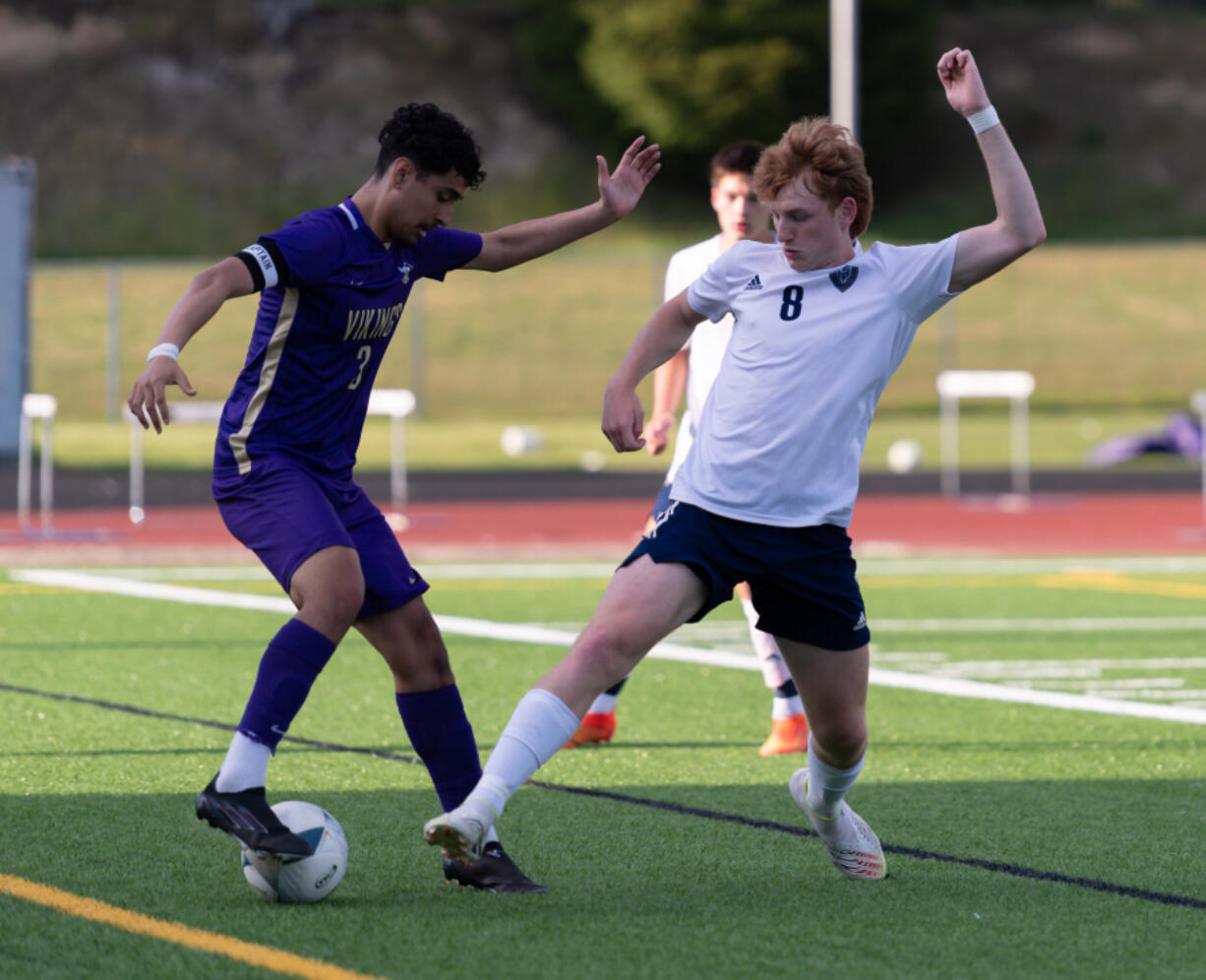 North Kitsap junior Mason Chmielewski dribbles past Hockinson senior forward Igor Povazhniuk in a WIAA 2A State Boys Soccer first-round game on Tuesday at North Kitsap High School in Poulsbo.