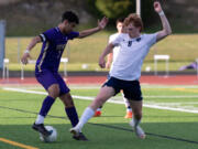 North Kitsap junior Mason Chmielewski dribbles past Hockinson senior forward Igor Povazhniuk in a WIAA 2A State Boys Soccer first-round game on Tuesday at North Kitsap High School in Poulsbo.