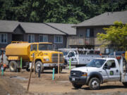 Apartments look over construction vehicles on a site along Northeast 138th Avenue in Vancouver.