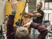 World class double bassist Xavier Foley, right, answers questions from fascinated Jason Lee Middle School students on Tuesday at the school.