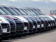 FILE - A line of unsold 2018 Cooper Clubmen sit in a long row at a Mini dealership, March 30, 2018, in Highlands Ranch, Colo. Lawmakers on Capitol Hill are pushing to keep AM radio in the nation's cars. A bipartisan group in Congress on Wednesday, May 17, 2023, introduced the "AM for Every Vehicle Act." The bill calls on the National Highway Traffic Safety Administration to require automakers to keep AM radio in new cars at no additional cost.