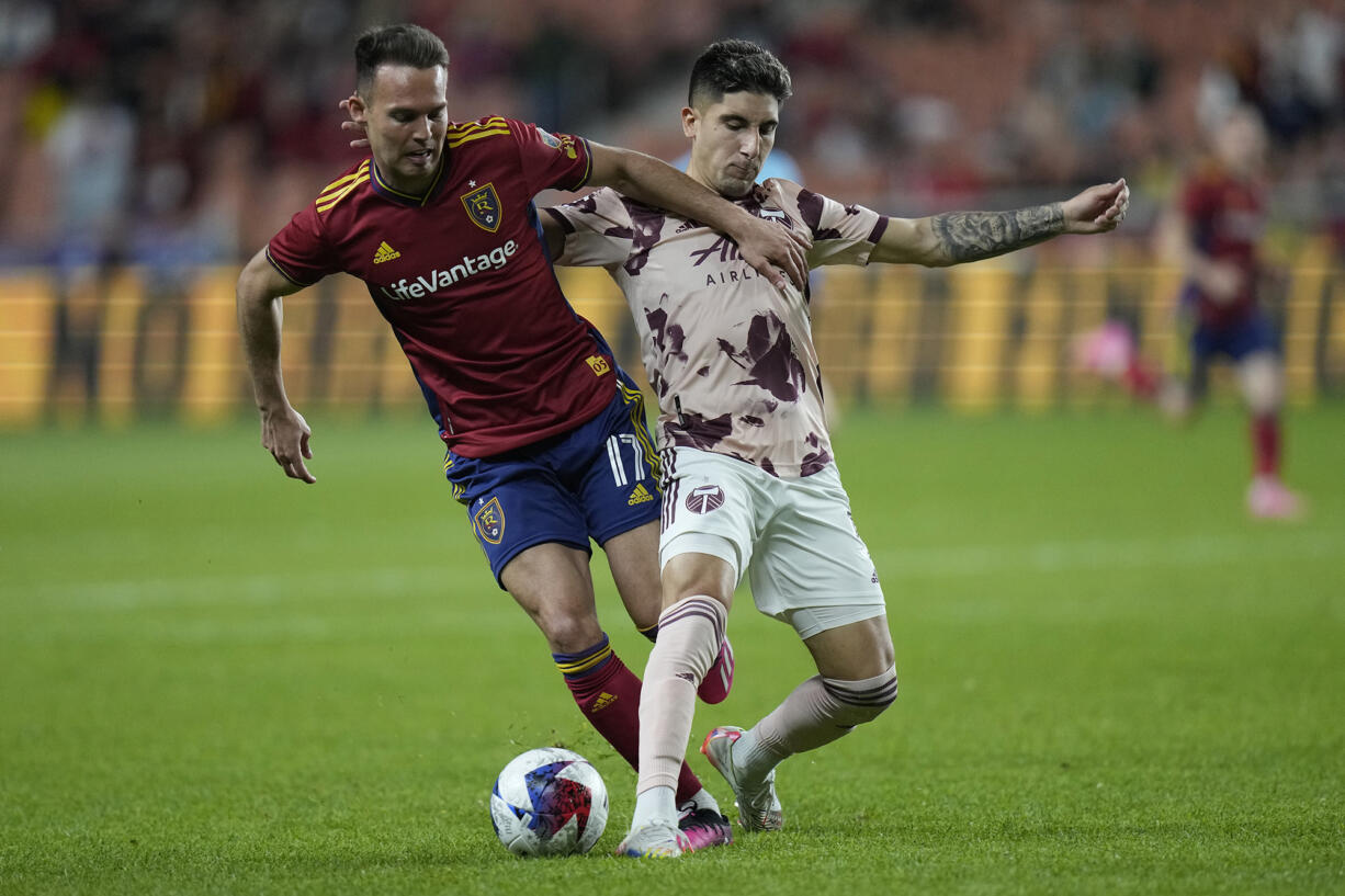Real Salt Lake forward Danny Musovski (17) and Portland Timbers defender Claudio Bravo, right, compete for the ball during the second half of an MLS soccer match Wednesday, May 17, 2023, in Sandy, Utah.