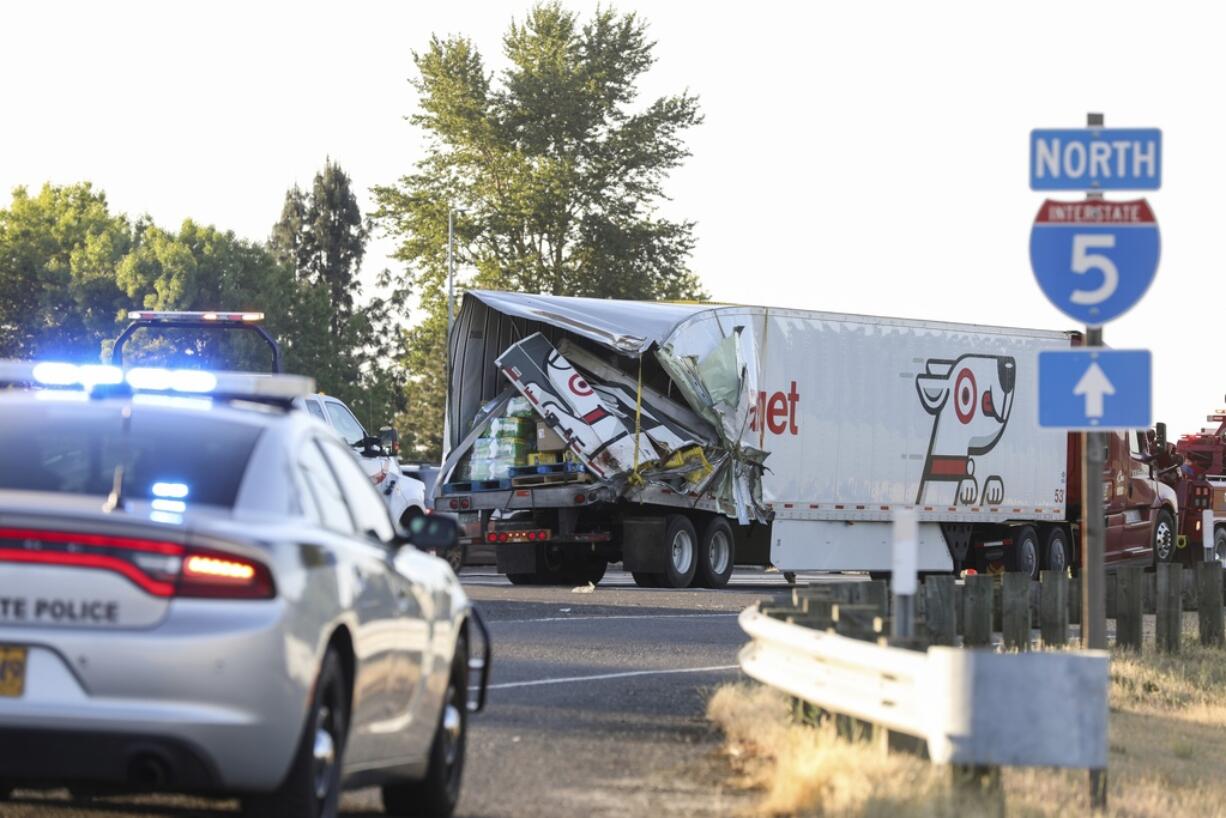 The back end of a semi-truck sits along Interstate 5, on Thursday, May 18, 2023, in Marion County, Ore.  Two semi-trucks and a passenger van were involved a deadly crash, which occurred near the city of Albany in an agricultural area of western Oregon, state police said on Thursday.