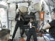 In this image from NASA TV, Ali al-Qarni, second from left, and Rayyanah Barnawi of Saudi Arabia, second right, have a drink alongside two cosmonauts in the International Space Station, Monday, May 22, 2023. The space station rolled out the welcome mat for the two Saudi visitors, including the kingdom's first female astronaut.