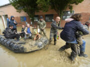 People are rescued in Faenza, Italy, Thursday, May 18, 2023. Exceptional rains Wednesday in a drought-struck region of northern Italy swelled rivers over their banks, killing at least nine people, forcing the evacuation of thousands and prompting officials to warn that Italy needs a national plan to combat climate change-induced flooding.