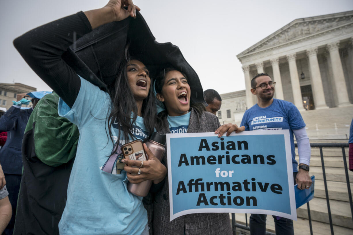 FILE - Harvard students Shruthi Kumar, left, and Muskaan Arshad, join a rally with other activists as the Supreme Court hears oral arguments on a pair of cases that could decide the future of affirmative action in college admissions, in Washington, Monday, Oct. 31, 2022. A new poll from The Associated Press-NORC Center for Public Affairs Research found that 63% of Americans say the Supreme Court should not stop colleges from considering race or ethnicity in their admission systems. (AP Photo/J.