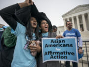 FILE - Harvard students Shruthi Kumar, left, and Muskaan Arshad, join a rally with other activists as the Supreme Court hears oral arguments on a pair of cases that could decide the future of affirmative action in college admissions, in Washington, Monday, Oct. 31, 2022. A new poll from The Associated Press-NORC Center for Public Affairs Research found that 63% of Americans say the Supreme Court should not stop colleges from considering race or ethnicity in their admission systems. (AP Photo/J.