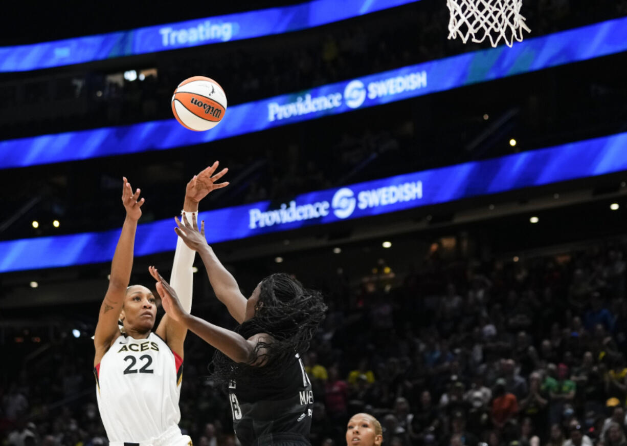 Las Vegas Aces forward A'ja Wilson (22) shoots over Seattle Storm center Ezi Magbegor (13) during the first half of a WNBA basketball game, Saturday, May 20, 2023, in Seattle.