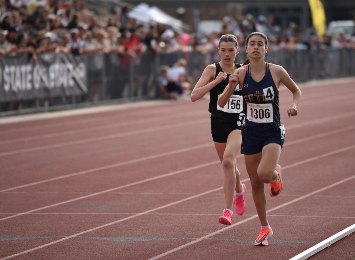 Seton Catholic junior Alexis Leone, right, leads Port Townsend's Aliyah Yearian during the 1,600 meters at the Class 1A state track and field championships on Thursday, May 25, 2023 at Zaepfel Stadium in Yakima. Leone won in 4 minutes, 59.30 seconds to repeat as state champion.